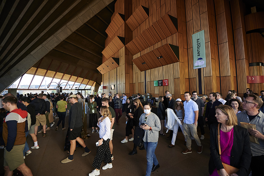 Crowds walk out of the main theatre at the Sydney Opera House.